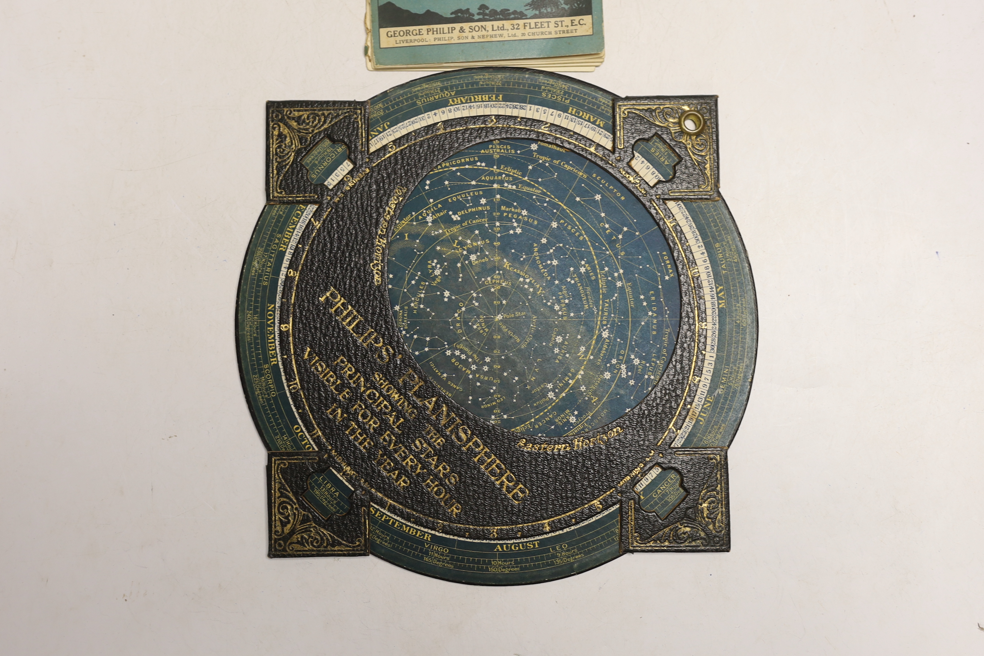 A Philips Planisphere showing principle stars visible every hour in the year and a volume of ‘Stars at a Glance’ pub. by Philip & Son, Planisphere 31cm high